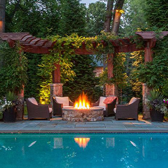 Fire Place in Backyard with Pool and Outdoor Wicker Furniture