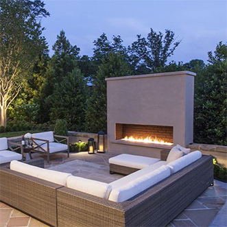 A cozy outdoor patio with a fireplace and comfortable seating area for relaxation and gatherings.