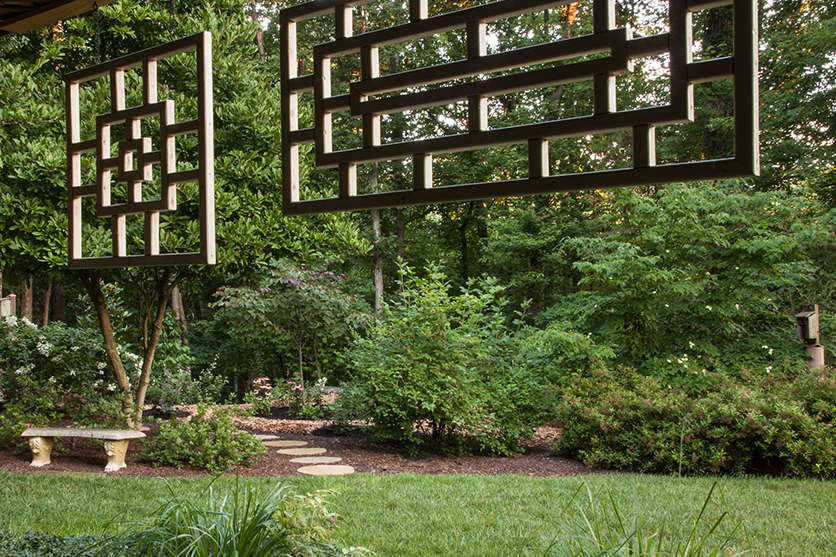 Backyard with Flowers, Bushes, and Tile Path