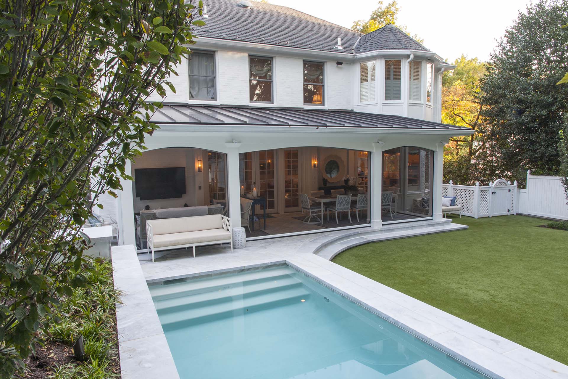 House with large back patio and connected swimming pool