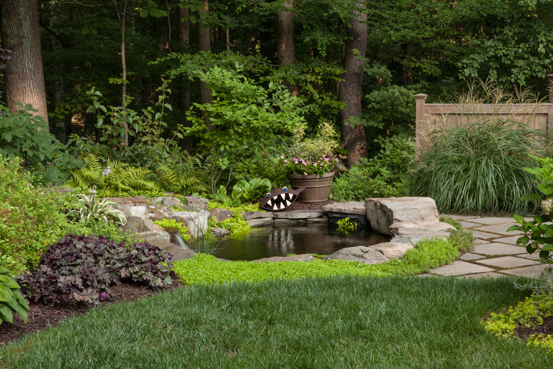 Water Feature in Backyard with Flowers around it