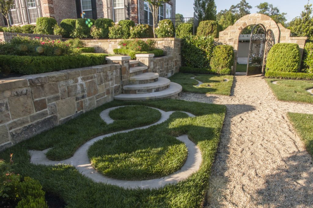 Front lawn with custom yard design and stone wall