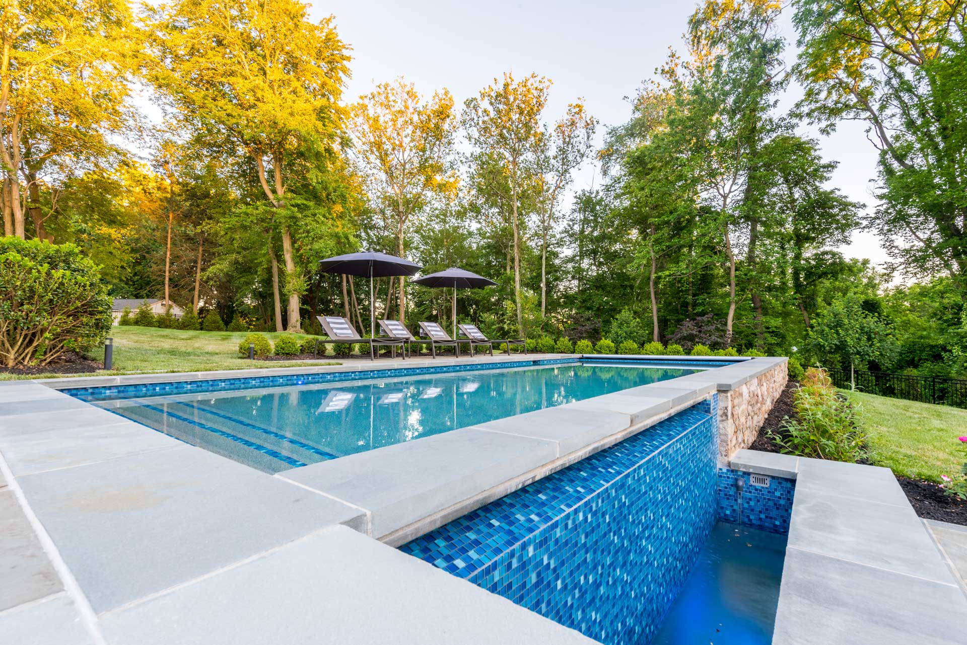 Modern Pool with Water Feture and Outdoor Furniture
