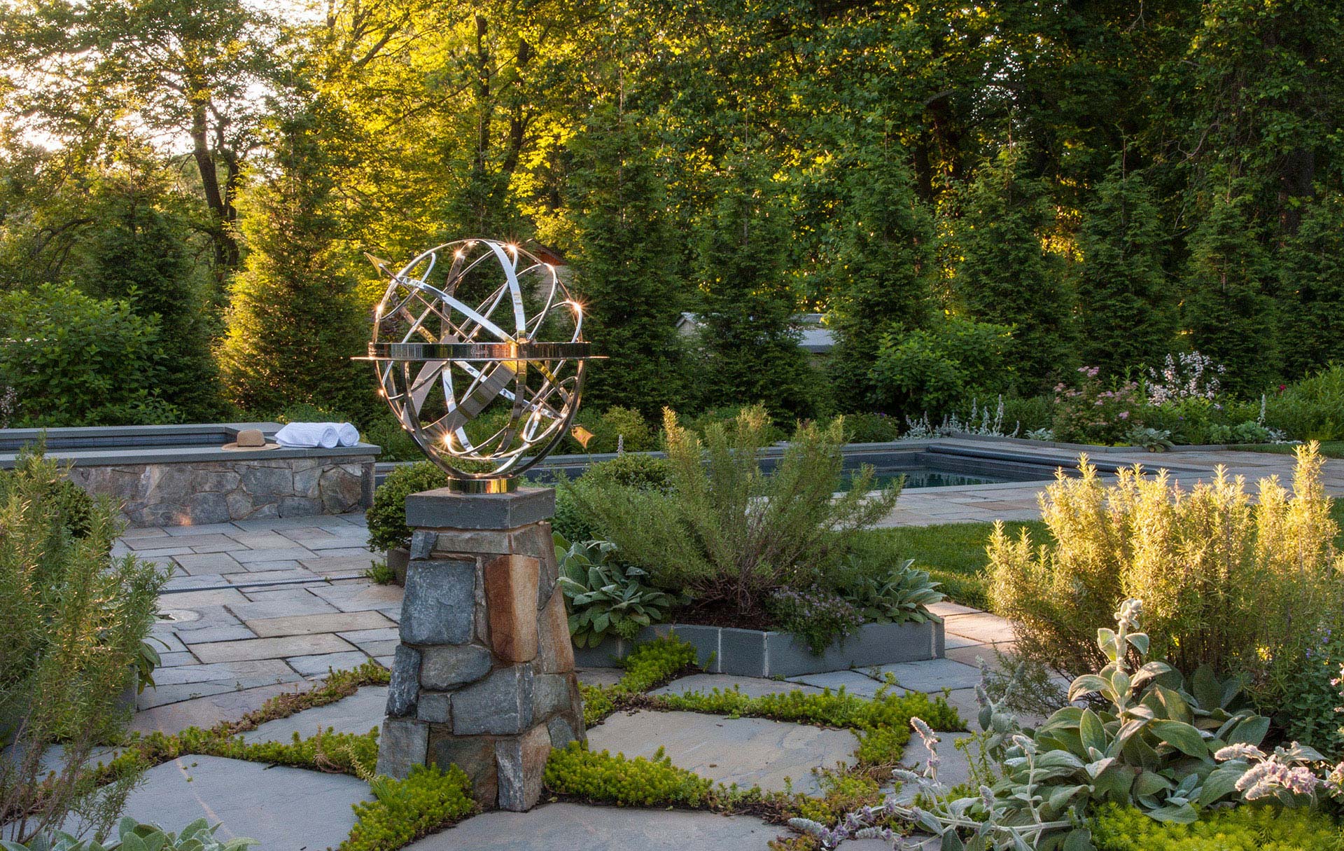 Water Feature in Backyard with Flowers around it