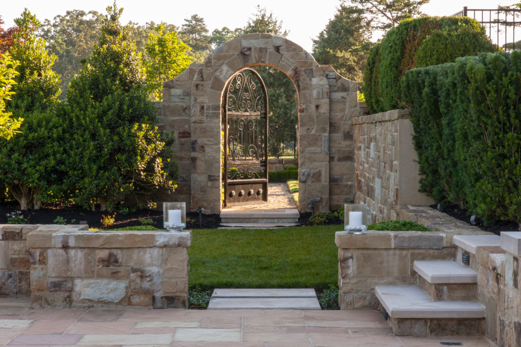 Arched stone front gate of a home.