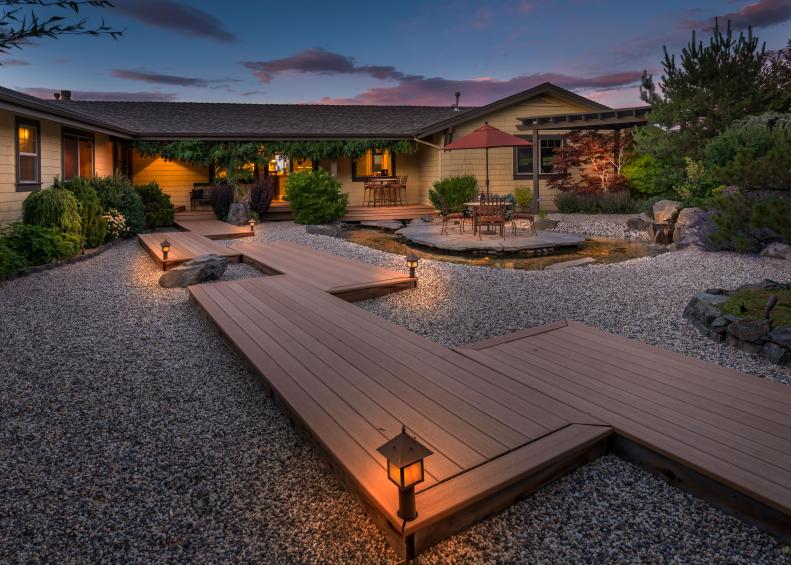 Large backyard with pea gravel and wood walkway