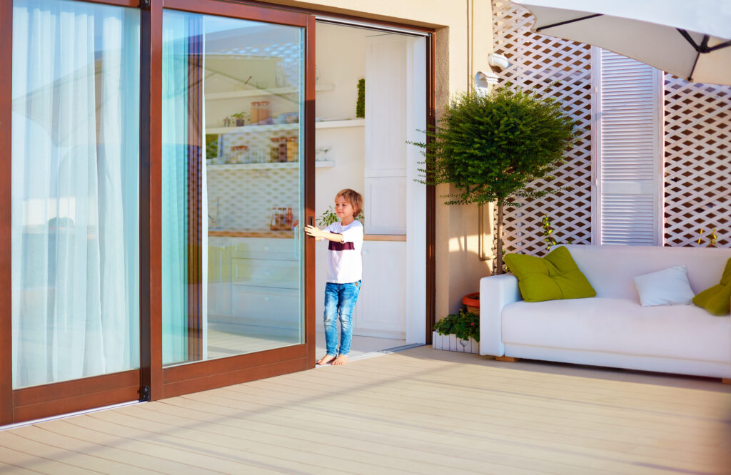 Child opening door to patio